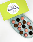 A box of Anniversary Chocolate + Strawberries Brigadeiros with "happy anniversary" written on it.