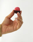 Hand holding a Strawberry brigadeiro