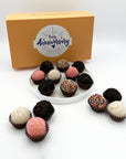 A plate of Anniversary Classic Celebration Brigadeiros with colorful sprinkles.