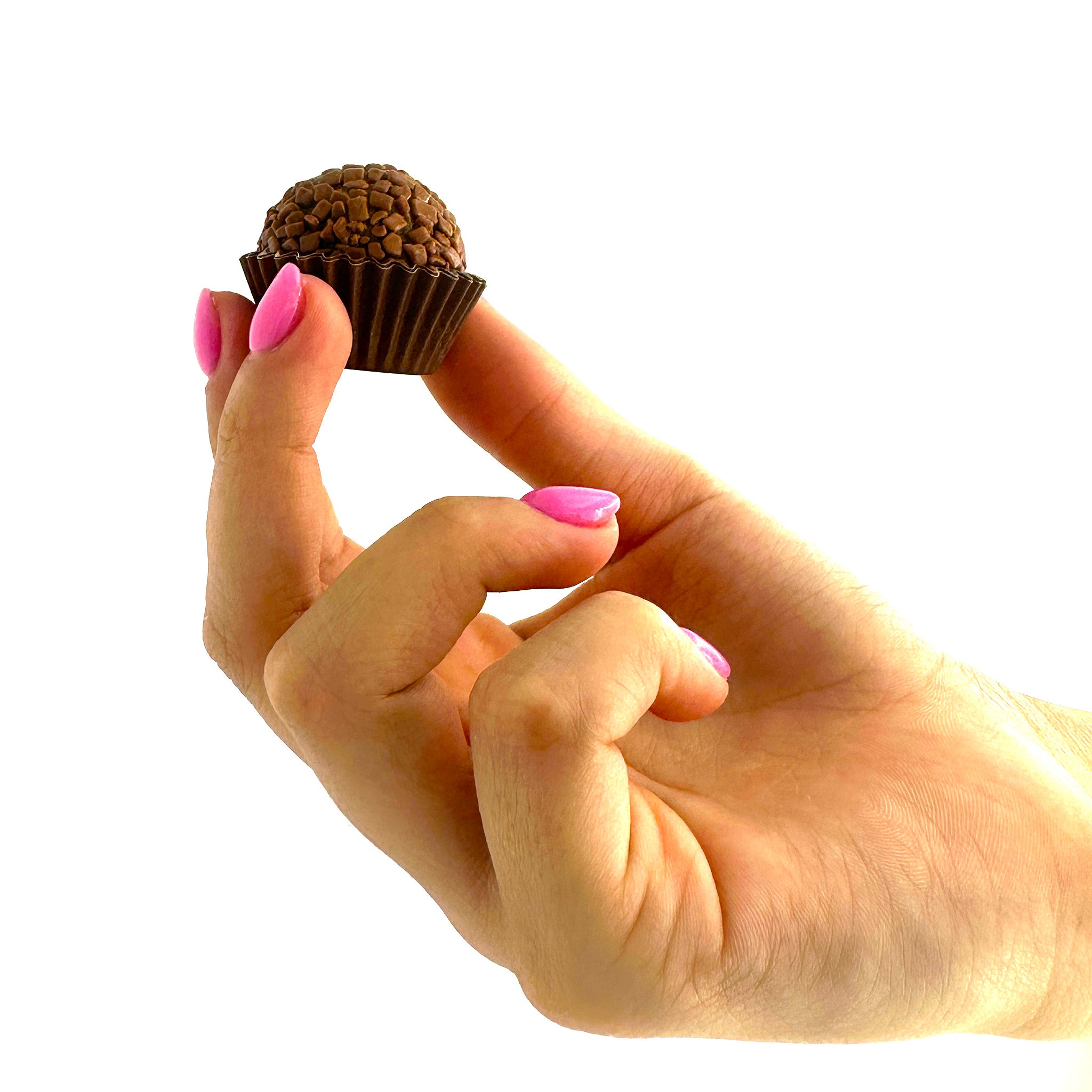 An Anniversary Chocolate Lovers Brigadeiros lover holding a brigadeiro truffle.