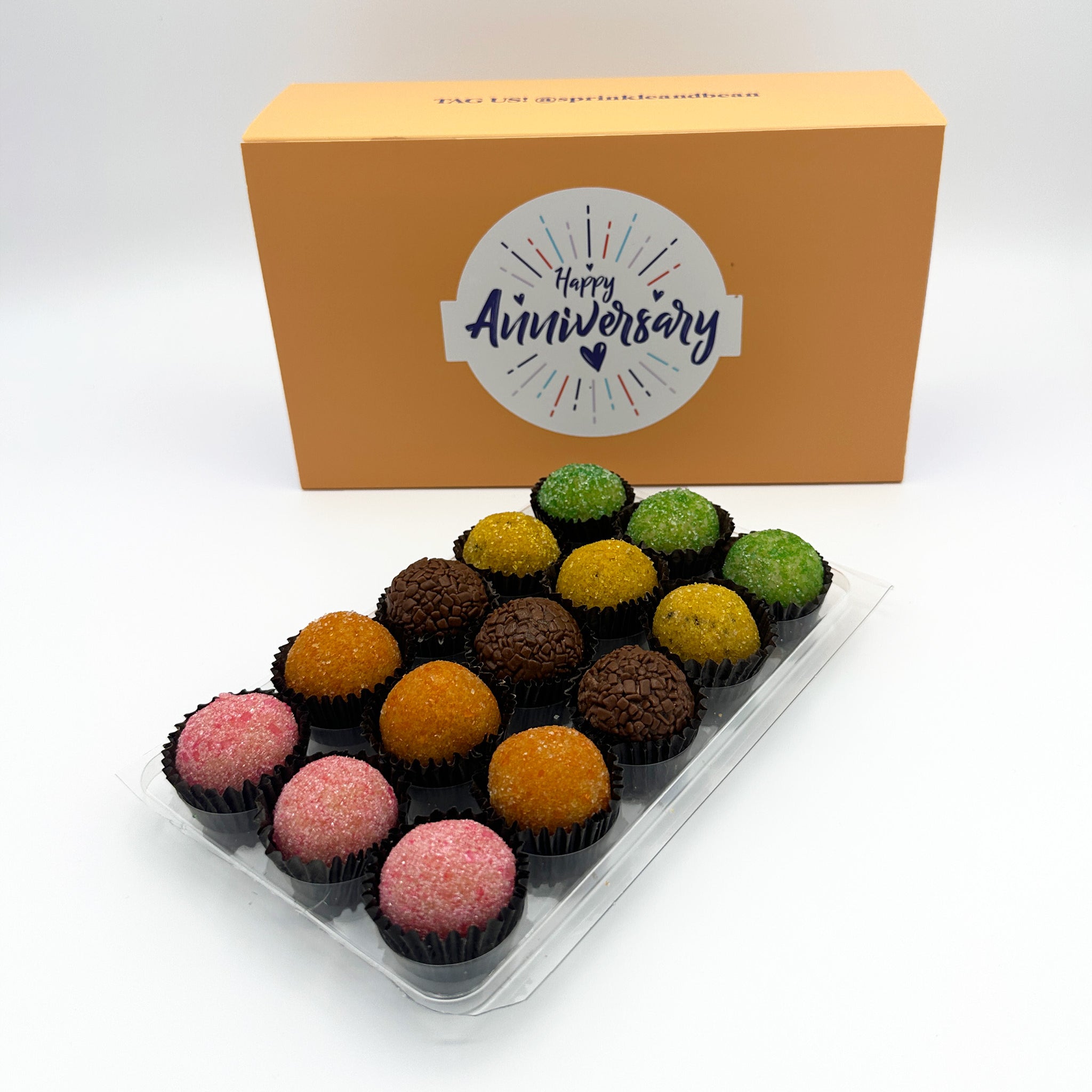 A sweet decision for an anniversary gift, a box of Anniversary Fruits Brigadeiros in a plastic container.