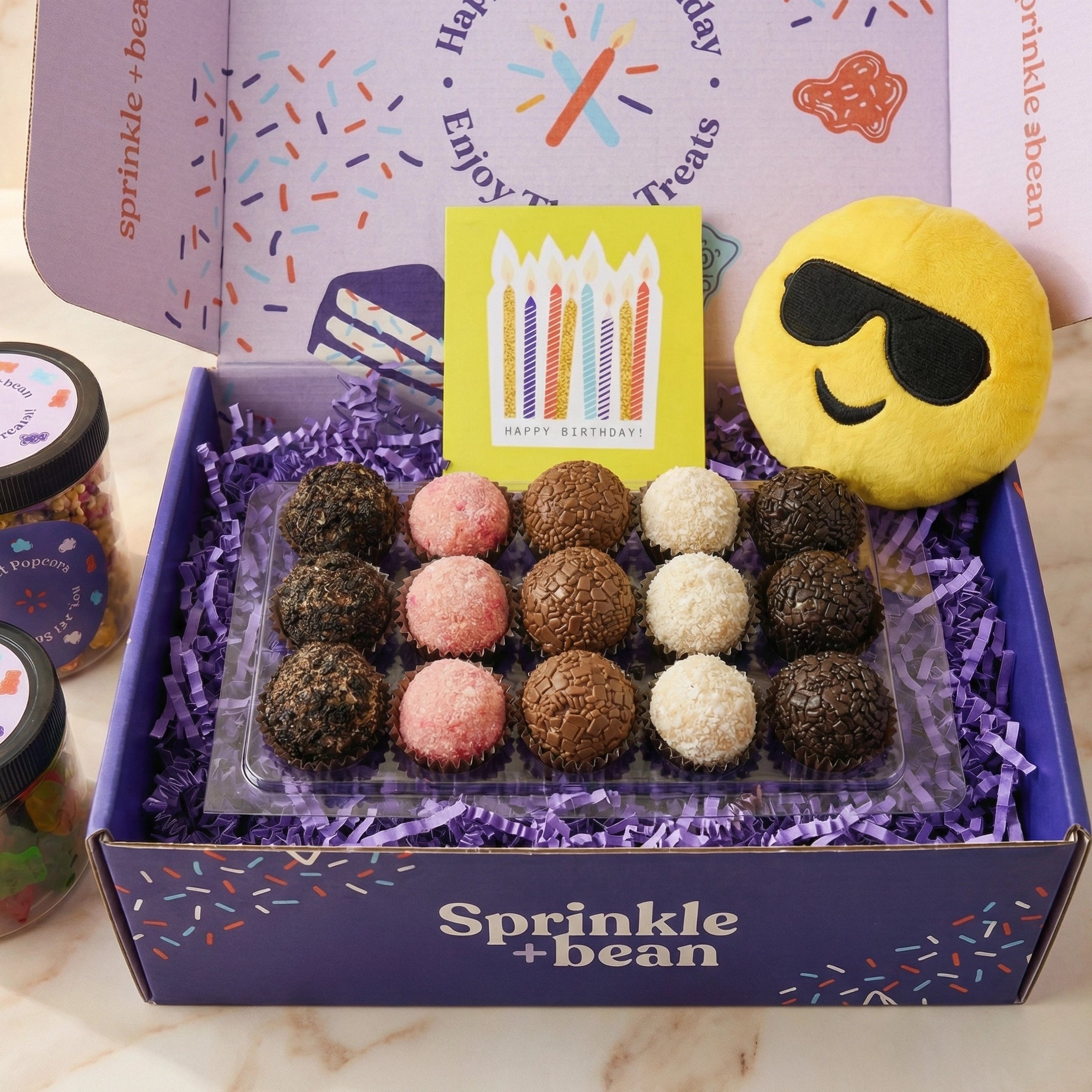 Birthday brigadeiro gift bundle with assorted chocolates, candy, and celebration card