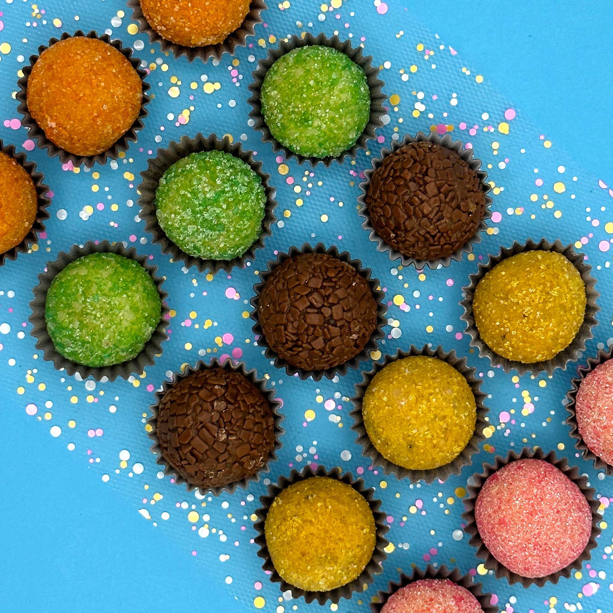 Anniversary Fruits Brigadeiros with sprinkles on a blue background are the perfect sweet decision for an anniversary gift.