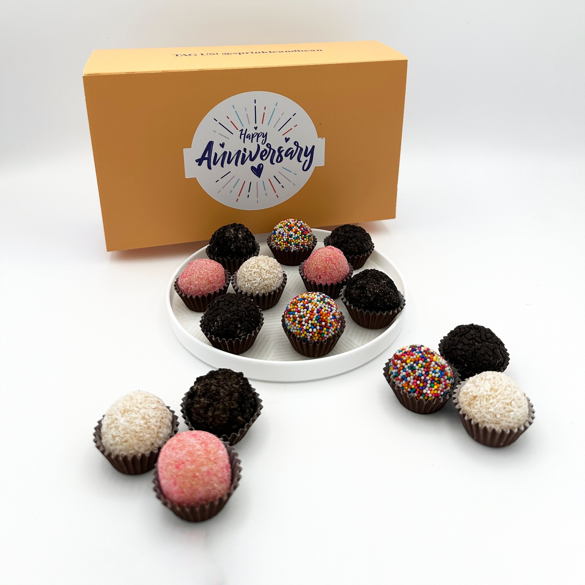 A plate of Anniversary Classic Celebration Brigadeiros with colorful sprinkles.